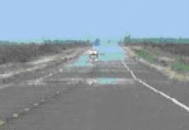 Heat rippling over asphalt road